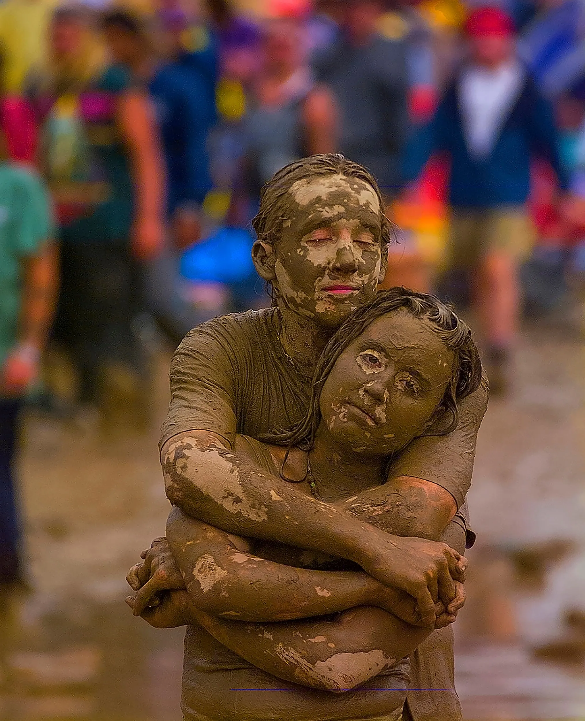 Mud Couple Hug — Standing on a muddy field during the 25th Anniversary concert of the 'Woodstock Music and Art Fair' Kyle Keyser, 21, wraps his arms around Linda Latzlsberger, 18, as they listen to 'Traffic' lead singer Steve Windwood sing their 1967 hit 'Dear Mr. Fantasy' during Woodstock '94 in Saugerties, New York, August 14, 1994. Both Keyser and Latzlsberger are from Baltimore.  (AP Photo/Stephan Savoia)  © The Associated Press