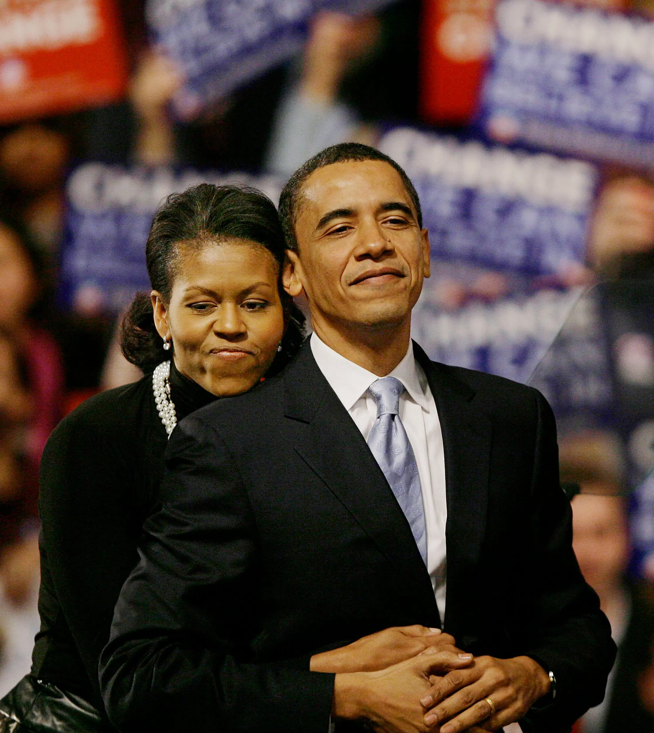 Runner Up — Democratic presidential hopeful Senator Barack Obama acknowledges the cheers of supporters while receiving a hug from his wife, Michelle, as they arrive on stage at his New Hampshire presidential primary election night rally in Nashua, New Hampshire, Tuesday night, January 8, 2008. Obama placed second behind rival New York Senator Hillary Clinton in the nation's presidential primary race.  (AP Photo/Stephan Savoia)  © The Associated Press