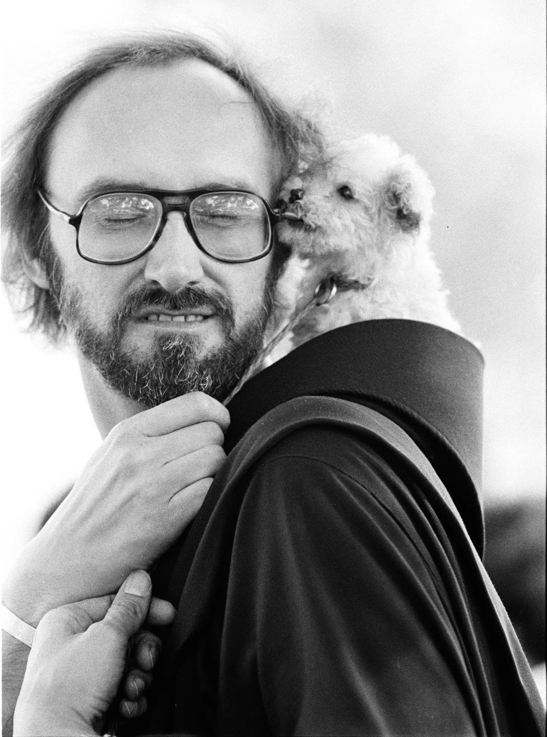 In Celebration of Animals — Franciscan priest, Reverend Father Charles Potocki, snuggles with a puppy after celebrating Mass outside of Saint Paschal Catholic Church in West Monroe, Louisiana on the Feast of Saint Anthony of Assisi, October 4, 1981. St Anthony of Assisi is recognized as the Patron Saint of Animals and Ecology. Father Potocki asked is parishioners to bring their pets to Sunday Mass so that he may bless them in the name of St Anthony.  (Photo by Stephan Savoia)  Published by The Monroe Louisiana News-Star-World Circa Early 1980s