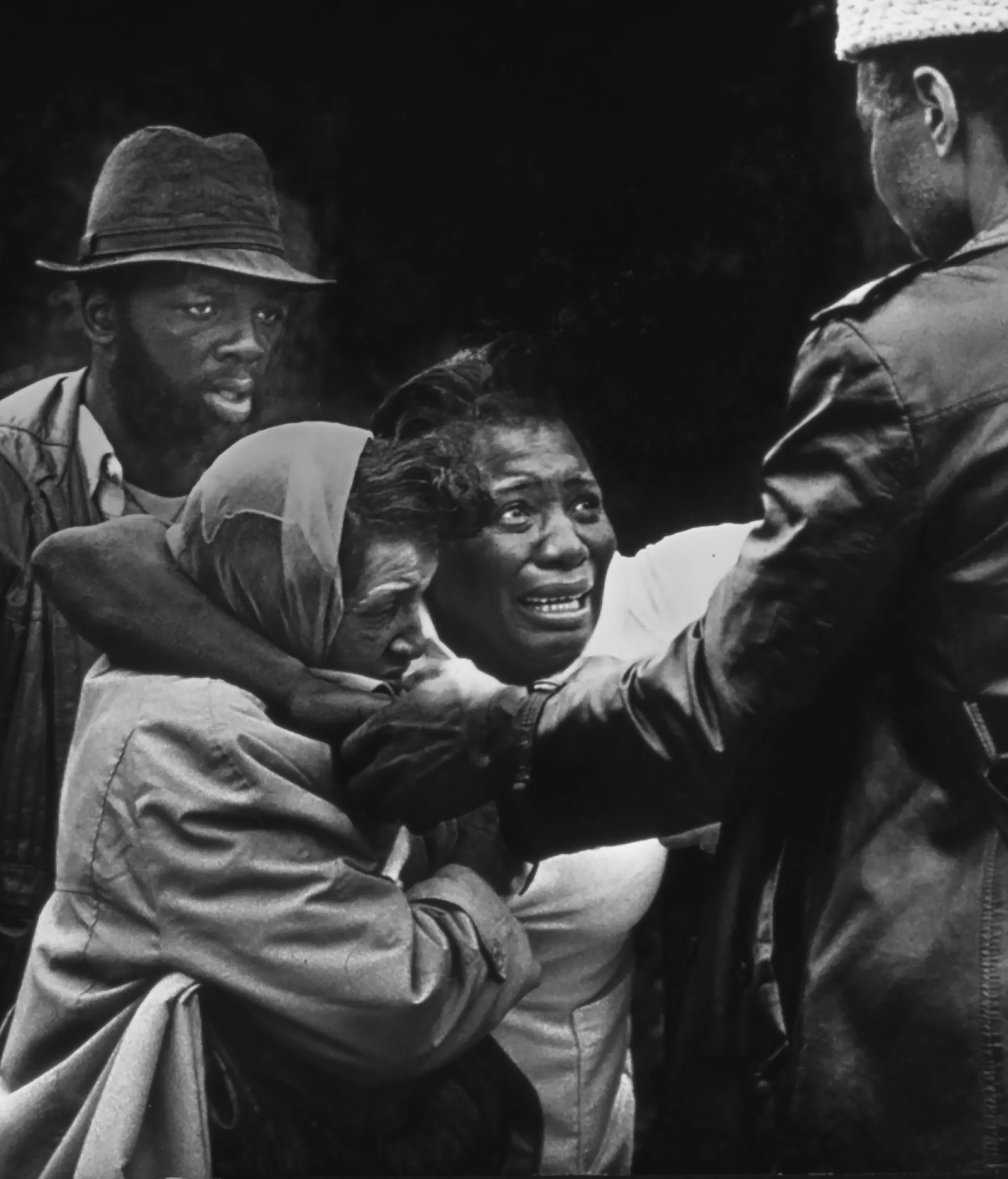 A Mother's Tragedy — Barbara McMillan, the grief stricken mother of Lanita McMillan Mitchell, 25, falls into the arms of loved-ones upon arriving outside her daughter’s home to learn her child had died. McMillan Mitchell was fatally shoot and killed by her estranged husband in Monroe, Louisiana. Mitchell’s killer was booked and charged with second degree murder.  (Photo by Stephan Savoia)  Published by The Monroe Louisiana New-Star-World Circa 1981