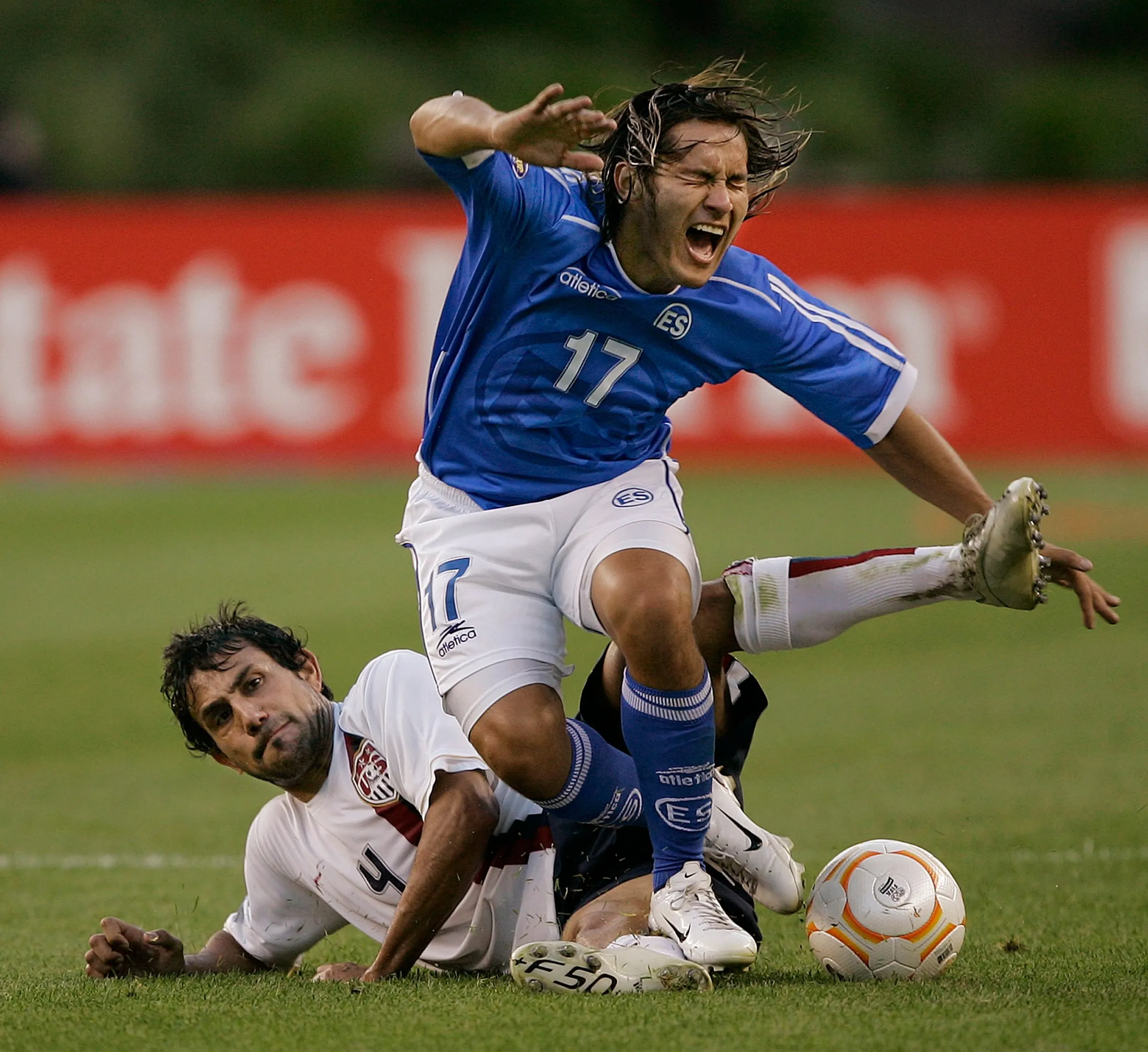 Yellow Card — El Salvador's Dennis Alas, 17, is tripped up by the United States' Pablo Mastroeni, 4, during first half action of their CONCACAF Gold Cup soccer match on Tuesday night, June 12, 2007 in Foxborough, Massachusetts. Mastroeni was issued a yellow card for tripping on the play.  (AP Photo/Stephan Savoia)  © The Associated Press