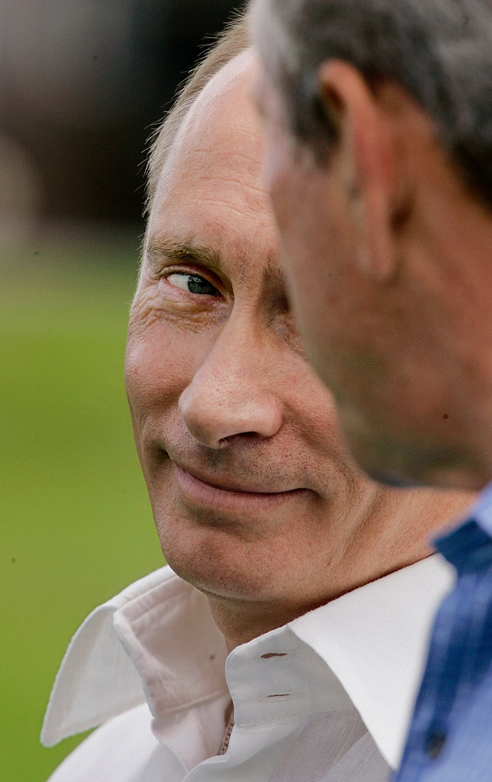 An Unholy Grin — Russian President Vladimir Putin, left, looks at President George W. Bush as they talk about their meetings, Monday, July 2, 2007, at the Bush family compound on Walker's Point in Kennebunkport, Maine.  (AP Photo/Stephan Savoia)  © The Associated Press