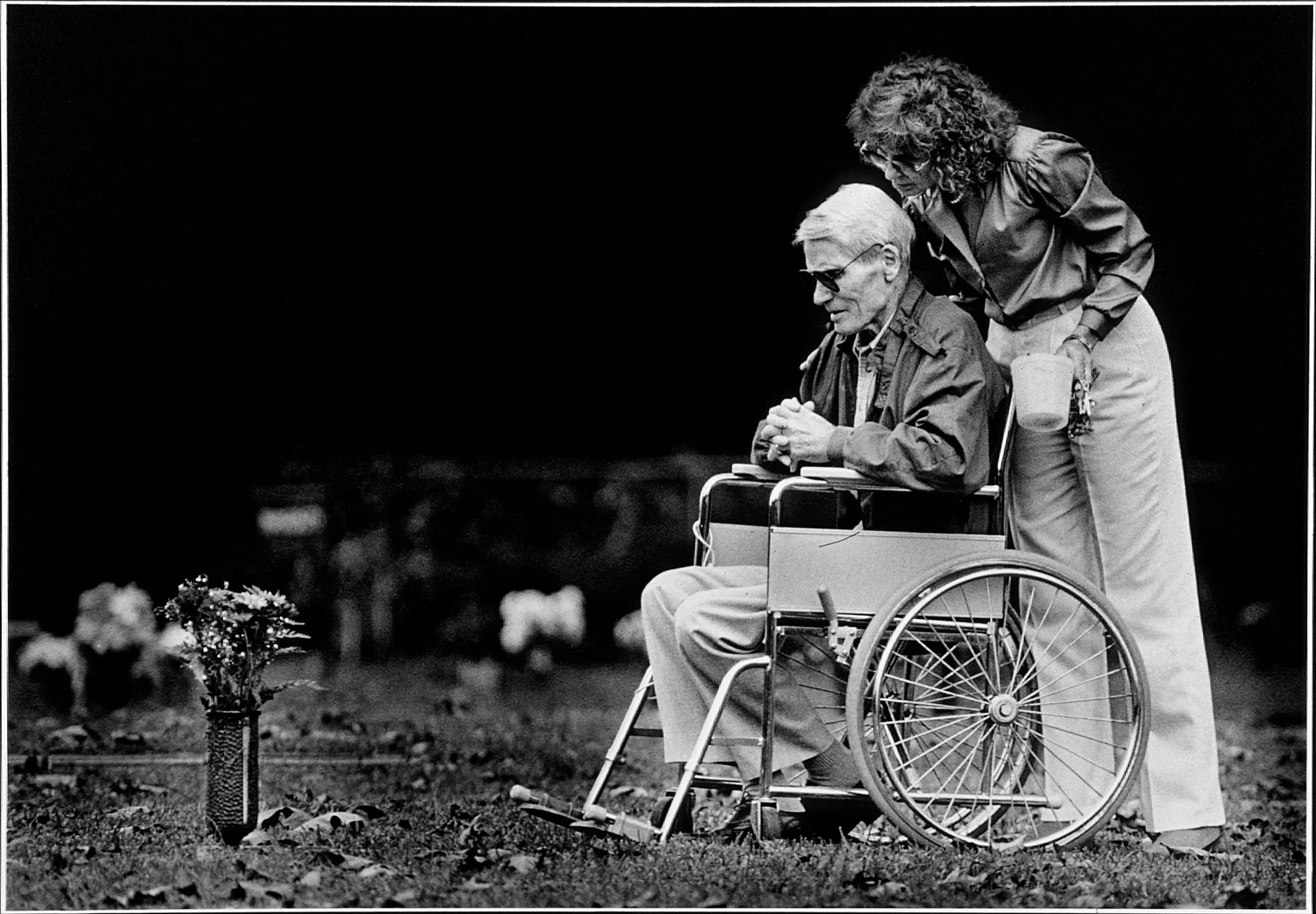 Here & There — Dying of prostate cancer, Percy Hood visits his first wife's grave with his second wife Nancy, 22 years his younger, in Baton Rouge, Louisiana. The reality that Percy will soon be resting at his first wife's side is not lost on either him or Nancy.  (Photo by Stephan Savoia)  Published by The Baton Rouge Louisiana Sunday Advocate Magazine