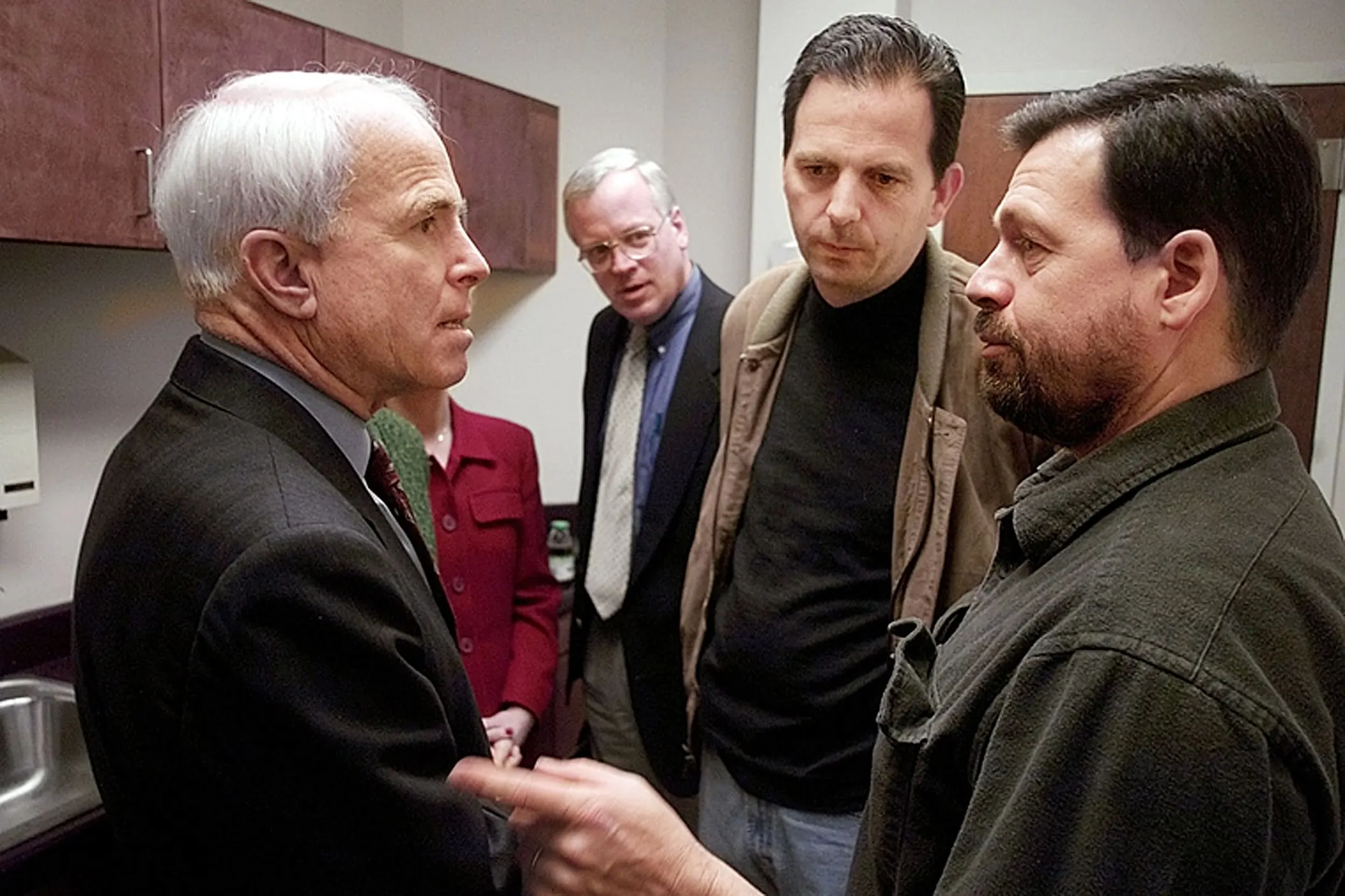 Push Back — Republican presidential candidate Senator John McCain, Arizona, is advised by his senatorial chief-of-staff, Mark Salter, and political director John Weaver to ask rival George W. Bush to stop the practice of push polling after McCain was told about a disturbing incident during a town hall style meeting in Spartanburg, South Carolina, on Thursday morning, February 10, 2000. McCain was told that 14-year-old Chris Duren had been push polled by the Bush campaign on Wednesday night. His mother, Donna Duren, said her son views McCain as a role model and hero who was upset by the telephone call.  (AP Photo/Stephan Savoia)  © The Associated Press