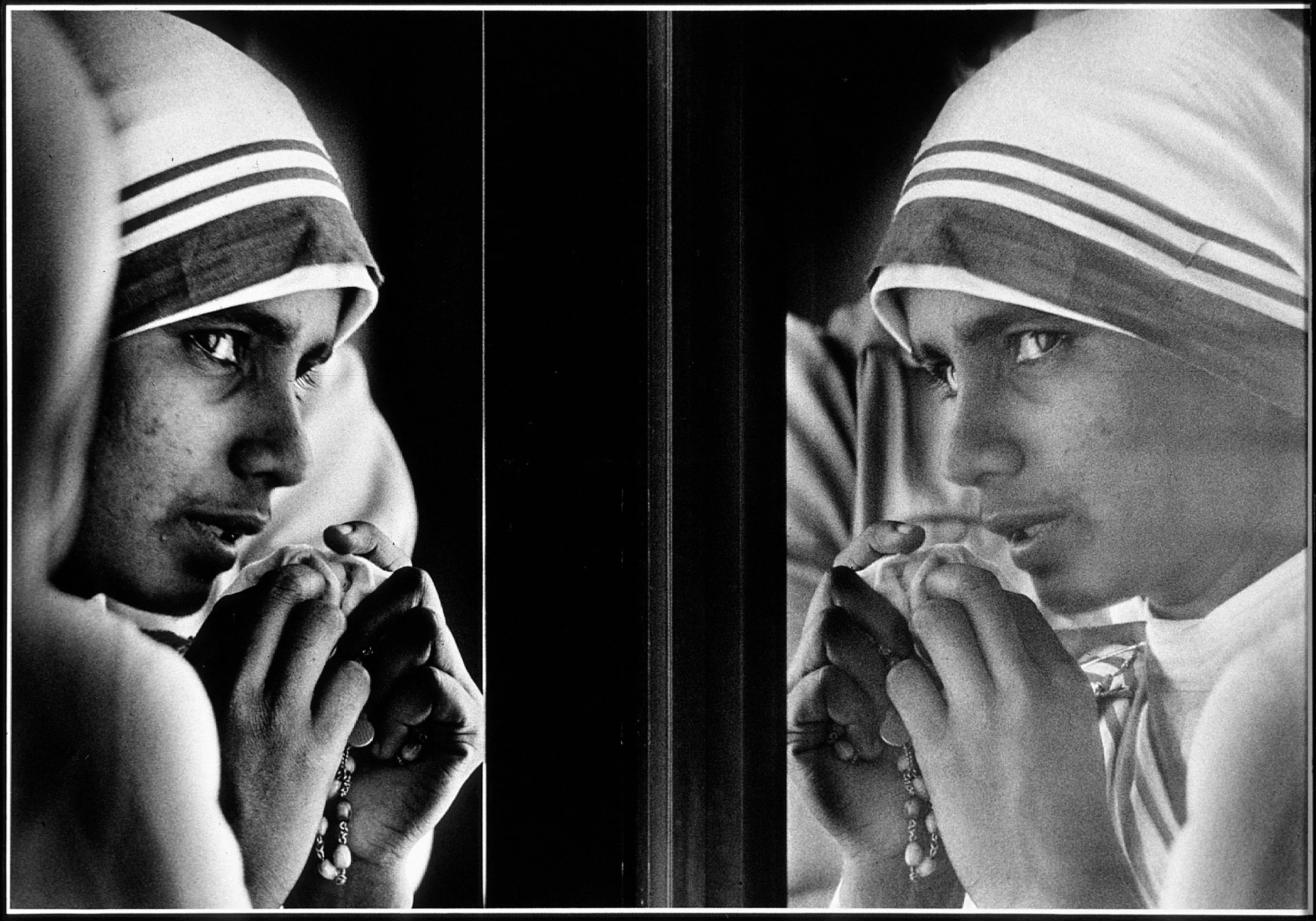 Tearful Good-bye — Sister Scholastica, one of three “Missionaries of Charity” nuns left in Baton Rouge, Louisiana, by Mother Teresa to begin a mission of charity, watches from an airport terminal window as Mother Teresa's plane taxis down a runway beginning the now canonized saint’s return to India.  (Photo by Stephan Savoia)  Published by The Baton Rouge Louisiana State-Times & Morning Advocate