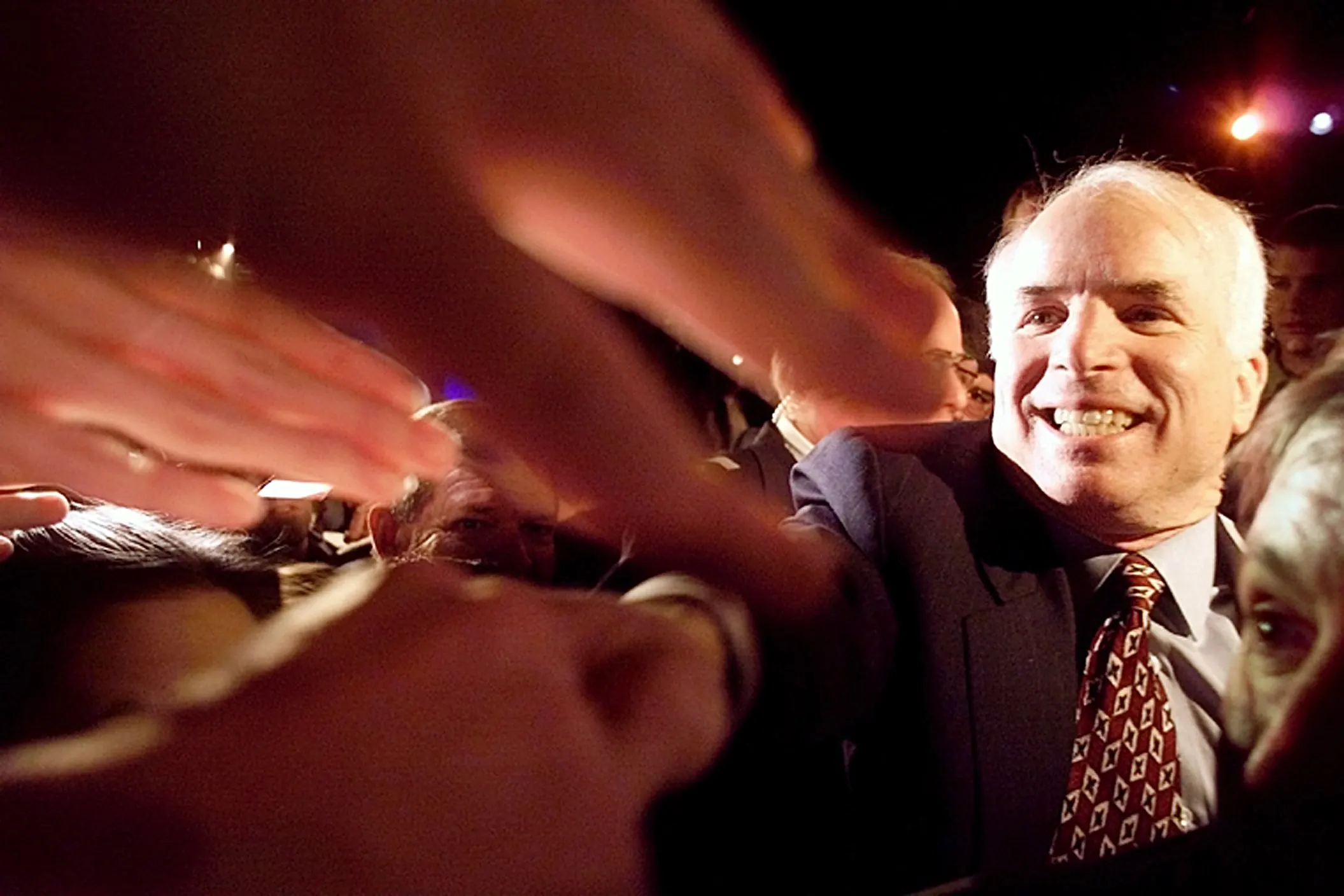 Voters to Greet & Hands To Shake — Republican presidential candidate Senator John McCain, Arizona, reaches into a crowd of Clemson University students to shake their hands after a McCain 2000 campaign rally at Clemson University on Wednesday night, February 16, 2000. McCain is campaigning in South Carolina for that state's upcoming presidential primary.  (AP Photo/Stephan Savoia)  © The Associated Press