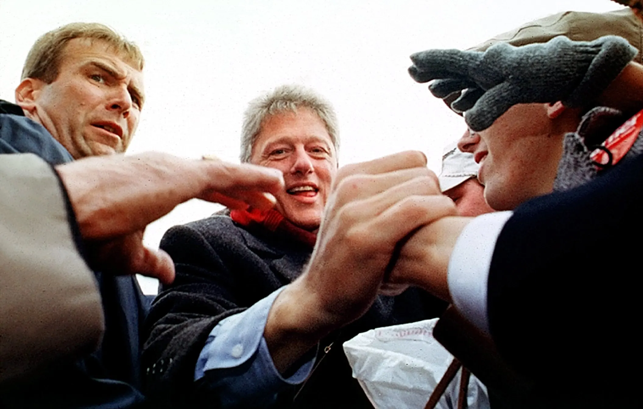 One Man's Stress Is Another Man's Joy — Democratic presidential candidate Bill Clinton works the crowd after a campaign rally as a Secret Service agent is primed to protect the candidate from overly handsy well-wishers in Cleveland, Ohio, on November 2, 1992. Clinton is four stops into a grueling nonstop 10-city campaign event schedule, with six stops remaining, before he arrives in Little Rock, Arkansas, on Election Day, November 3rd, to cast his vote.  (AP Photo/Stephan Savoia)  © The Associated Press