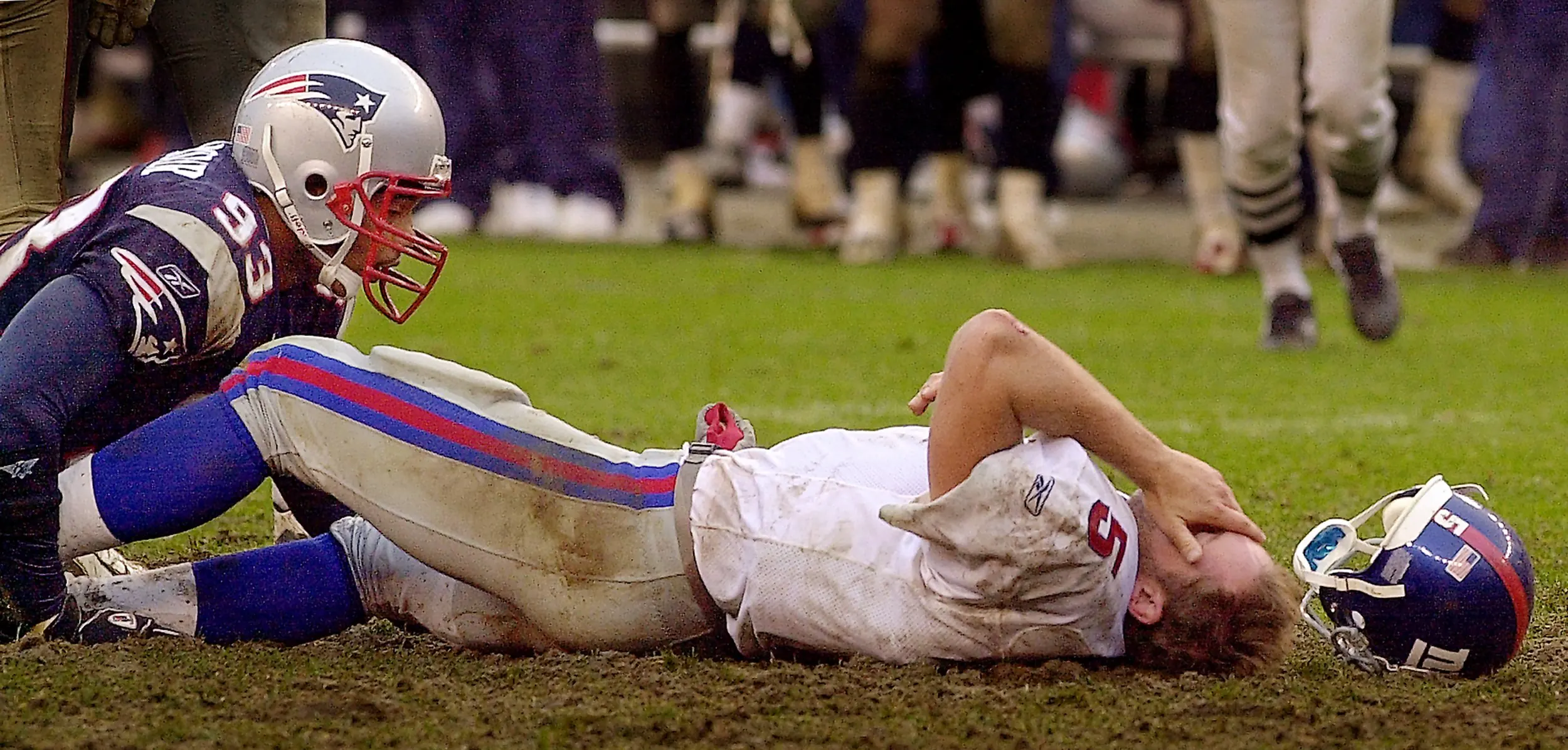 Yelberton's Legacy — New York Giants quarterback Kerry Collins covers his face after being sacked by New England Patriots defensive lineman Richard Seymore (95) during fourth quarter action of their NFL game in Foxboro, Massachusetts, Sunday afternoon October 12, 2003. Collins left the game as the Patriots defeated the Giants 17-6.  (AP Photo/Stephan Savoia)  © The Associated Press