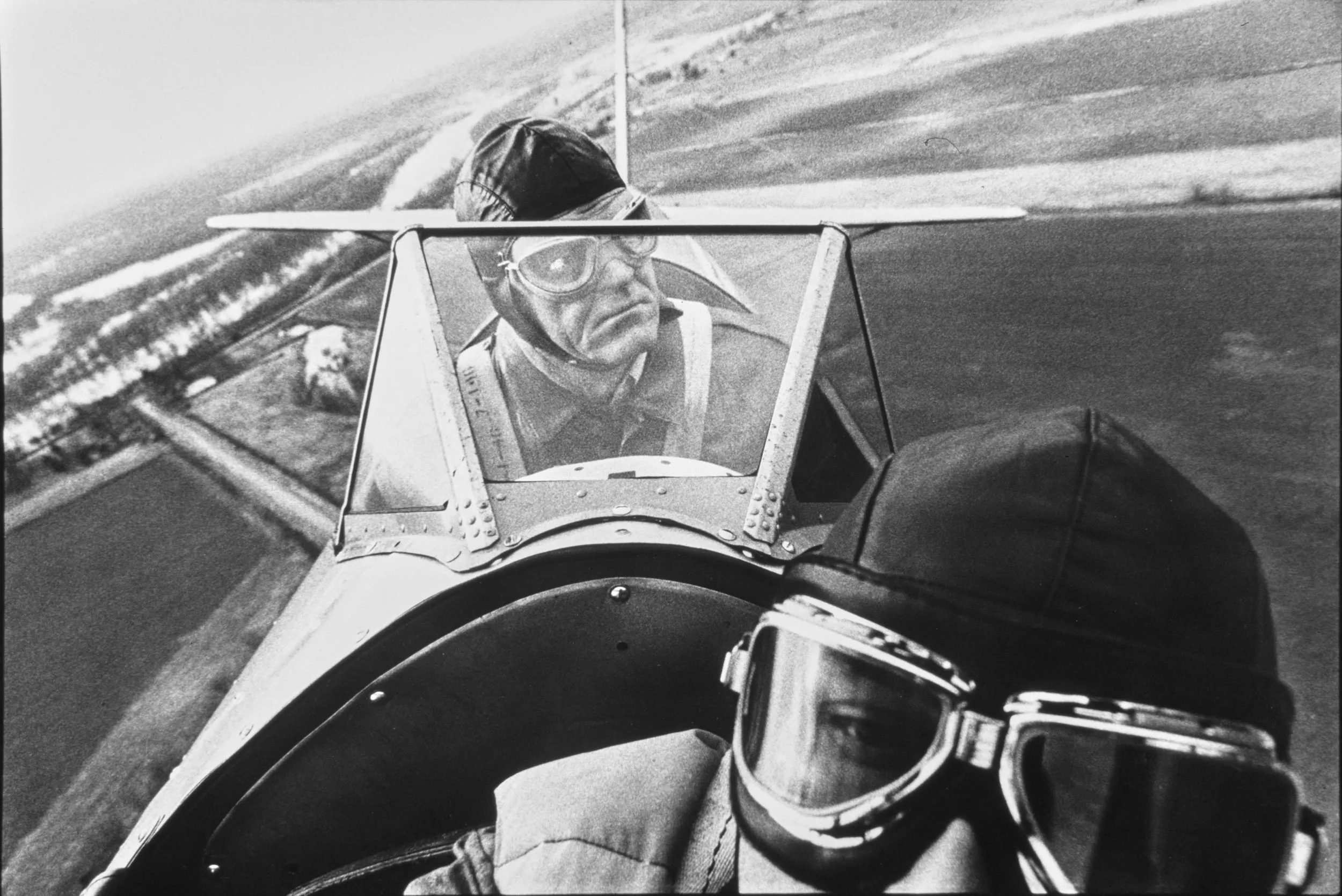 Flying Old School — Jack Keahey, center, prefers to pilot his restored 1942 Boeing - Stearman PT-13 biplane trainer from the second seat where, at an altitude of 1,000 feet and an airspeed of 100 miles per hour, he surveys the air space around his aircraft.  (Photo by Stephan Savoia)  Published by The Monroe Louisiana News-Star-World Circa Early 1980s